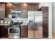 Close-up of the kitchen with stainless steel appliances, range, microwave and wood cabinets at 6231 Indian Paintbrush St # 214, Frederick, CO 80530