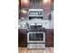 Close-up of stainless steel range with microwave and cabinets at 6231 Indian Paintbrush St # 214, Frederick, CO 80530