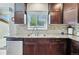 Close-up of the kitchen with a stainless steel dishwasher and double sink under the window at 6231 Indian Paintbrush St # 214, Frederick, CO 80530