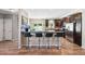 Stylish kitchen with granite countertops, stainless steel appliances, breakfast bar, and wood flooring at 6231 Indian Paintbrush St # 214, Frederick, CO 80530