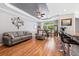Comfortable living space featuring wood floors, grey walls, and a statement Gathering tree decoration at 6231 Indian Paintbrush St # 214, Frederick, CO 80530