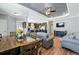 Inviting living area flows into kitchen, featuring wood floors, a breakfast bar, and modern decor at 6231 Indian Paintbrush St # 214, Frederick, CO 80530