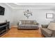Cozy living room featuring a fireplace, hardwood floors, grey walls, and a comfortable grey sofa at 6231 Indian Paintbrush St # 214, Frederick, CO 80530