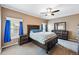 Spacious bedroom features a ceiling fan, natural light, carpet flooring, and traditional furniture at 6231 Indian Paintbrush St # 214, Frederick, CO 80530