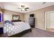 Neutral bedroom with a ceiling fan, a wooden dresser, and a gray carpet at 6231 Indian Paintbrush St # 214, Frederick, CO 80530