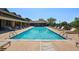 Sparkling outdoor community pool surrounded by ample lounge chairs for residents at 6231 Indian Paintbrush St # 214, Frederick, CO 80530