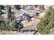 Aerial view of a two-story home featuring a blue exterior, solar panels, deck with outdoor seating, and fenced yard at 7464 Shoreham Pl, Castle Pines, CO 80108