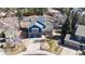 Overhead view of a lovely two-story home with solar panels, landscaped yard, mature trees and driveway at 7464 Shoreham Pl, Castle Pines, CO 80108