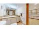 Well-lit bathroom featuring a vanity with ample storage, modern fixtures, and tile flooring at 7464 Shoreham Pl, Castle Pines, CO 80108