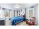 Charming bedroom with striped walls, windows, and vintage rocking chair, exuding a cozy ambiance at 7464 Shoreham Pl, Castle Pines, CO 80108