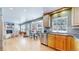 This kitchen features stainless appliances, a breakfast nook and access to the living room at 7464 Shoreham Pl, Castle Pines, CO 80108