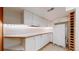 Basement kitchenette featuring white cabinets, ample countertop space, and modern appliances at 7464 Shoreham Pl, Castle Pines, CO 80108