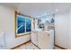 Functional laundry area equipped with modern washer and dryer, built-in shelving, and natural light at 7464 Shoreham Pl, Castle Pines, CO 80108