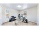 Bright office with a modern glass desk and neutral walls, perfect for a productive work environment at 7464 Shoreham Pl, Castle Pines, CO 80108