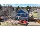 Two-story home featuring a well-maintained backyard with deck, modern outdoor seating, and mature landscaping at 7464 Shoreham Pl, Castle Pines, CO 80108