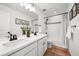 Bright bathroom features dual sinks, quartz countertop, with modern hardware and shower at 5078 S Quail St, Littleton, CO 80127