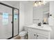 Modern bathroom with a glass door walk-in shower, single sink vanity and modern hardware at 5078 S Quail St, Littleton, CO 80127