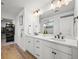 Bright bathroom features dual sinks, quartz countertop, with modern hardware and a walk-in closet at 5078 S Quail St, Littleton, CO 80127