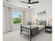 Bright bedroom with neutral color palette, ceiling fan, and view of backyard at 5078 S Quail St, Littleton, CO 80127