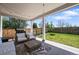 Inviting covered patio with string lights, comfortable seating, and a view of the backyard at 5078 S Quail St, Littleton, CO 80127