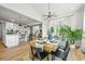 Dining area with wooden table, modern light fixture, and access to the kitchen at 5078 S Quail St, Littleton, CO 80127