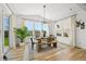 Bright dining area with a rustic table, modern lighting, and large sliding glass doors at 5078 S Quail St, Littleton, CO 80127
