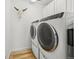 Modern laundry room featuring front load washer and dryer and bull skull decoration at 5078 S Quail St, Littleton, CO 80127