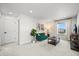 Bright and cozy living room with a green couch, natural light, and modern decor at 5078 S Quail St, Littleton, CO 80127