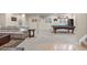 Open basement layout featuring a pool table and a cozy seating area with plush carpeting at 6132 S Boston Cir, Englewood, CO 80111