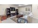 Inviting basement area with a large sectional sofa, entertainment unit, and warm lighting at 6132 S Boston Cir, Englewood, CO 80111