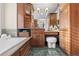 Bathroom with elegant wood cabinetry, decorative backsplash, tiled floor, vanity, and jacuzzi tub at 6132 S Boston Cir, Englewood, CO 80111