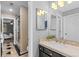 Bathroom with shower and decorative tile flooring leading to a bedroom with a ceiling fan at 6132 S Boston Cir, Englewood, CO 80111