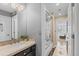 Bathroom featuring a decorative mirror and countertop, leading to a shower with sliding glass doors at 6132 S Boston Cir, Englewood, CO 80111