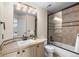 Elegant bathroom with a glass-enclosed tub and shower combo, stylish fixtures, and mosaic tile accents at 6132 S Boston Cir, Englewood, CO 80111