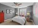 Comfortable bedroom featuring neutral walls, a ceiling fan, and framed art at 6132 S Boston Cir, Englewood, CO 80111