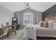 Bedroom featuring large shuttered windows, a desk area, and a comfortable bed with decorative pillows at 6132 S Boston Cir, Englewood, CO 80111