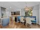 Bright dining area featuring a built-in dining bench, modern light fixture, and open to kitchen at 6132 S Boston Cir, Englewood, CO 80111