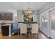 Inviting dining area with a built-in bench, modern lighting, and a sliding glass door at 6132 S Boston Cir, Englewood, CO 80111