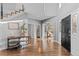 Grand foyer with hardwood floors, a modern staircase, and an arched doorway to a study at 6132 S Boston Cir, Englewood, CO 80111