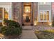 Inviting front entrance featuring a brick facade, arched entryway, and well-maintained landscaping at 6132 S Boston Cir, Englewood, CO 80111