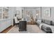 Bright home office with large windows, custom built-ins, and a comfortable sofa at 6132 S Boston Cir, Englewood, CO 80111