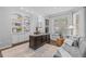 Bright home office with large windows, custom built-ins, and a comfortable sofa at 6132 S Boston Cir, Englewood, CO 80111