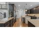 Modern kitchen with dark cabinetry, granite countertops, and stainless steel appliances at 6132 S Boston Cir, Englewood, CO 80111