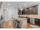 Stylish kitchen island with granite countertop, stainless steel appliances, and modern lighting at 6132 S Boston Cir, Englewood, CO 80111