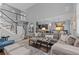 Spacious living room featuring a cozy sofa, a view of the kitchen and staircase at 6132 S Boston Cir, Englewood, CO 80111