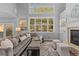 Comfortable living room with a fireplace, large windows, and a plush sofa at 6132 S Boston Cir, Englewood, CO 80111