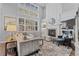 Spacious living room with soaring ceilings, a fireplace, and large windows offering natural light at 6132 S Boston Cir, Englewood, CO 80111