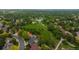 Picturesque aerial view showcasing lush green neighborhood with walking paths, ponds, and mature trees at 6132 S Boston Cir, Greenwood Village, CO 80111