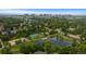 Scenic aerial view of community amenities including a pond, tennis courts, pool, playground, and walking paths at 6132 S Boston Cir, Greenwood Village, CO 80111