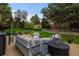 Inviting backyard featuring lush landscaping and outdoor seating around a modern fire pit at 6132 S Boston Cir, Greenwood Village, CO 80111